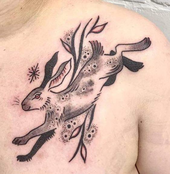 Traditional rabbit trick inspired tattoo on the left