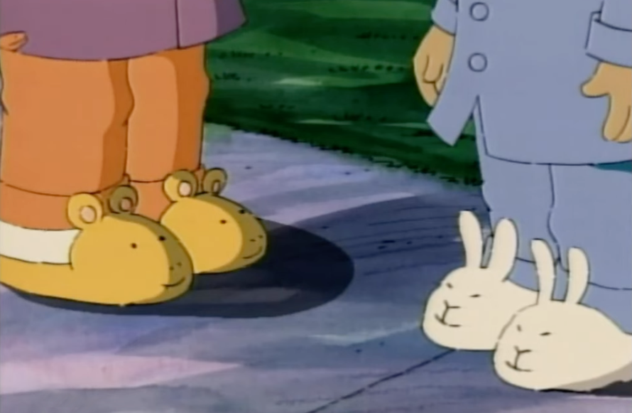 buster's feet wear a pair of aardvark slippers and arthur's feet wear a pair of bunny slippers