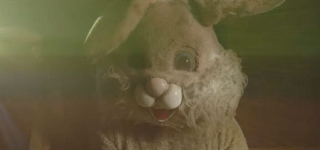 An Easter Bunny costume head close-up, the fur looks matted and dirty.