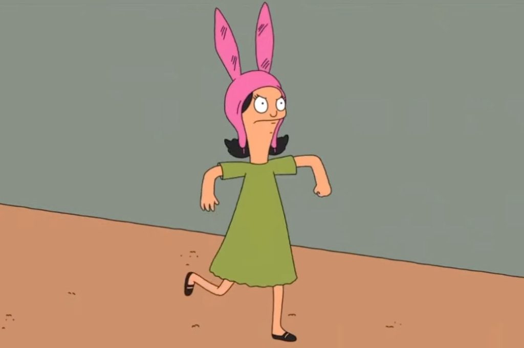 A cartoon girl wears a green dress and pink hat with bunny ears and looks angry.