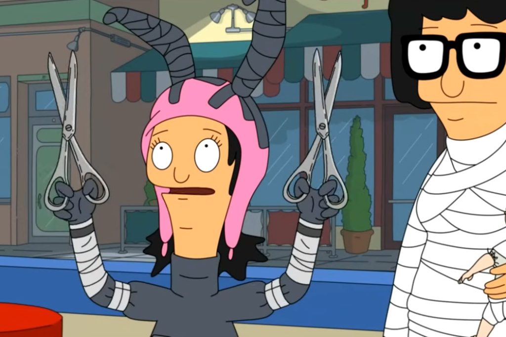 A cartoon girl with pink bunny ears wears an Edward Scissorhands costume and holds scissors in her hands. Another cartoon character dressed as a mummy stands behind her.